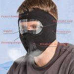 Man wearing black winter face mask with goggles and anti-fog breath vent.