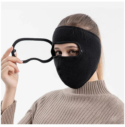 Woman wearing black fleece winter face mask with detachable eye cover, beige sweater